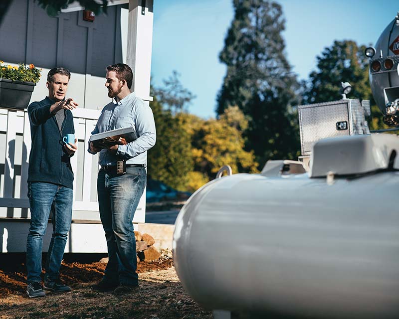 propane tank service worker with customer